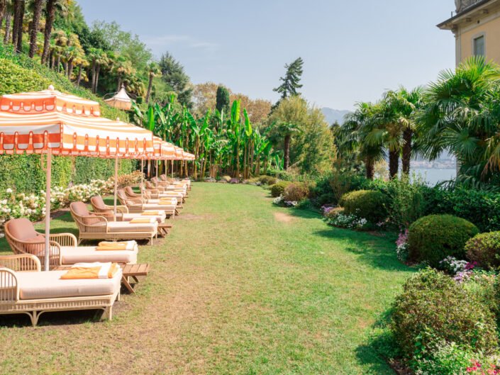 The peaceful garden and lounging area of Grand Hotel Tremezzo overlooking Lake Como, a tranquil oasis for relaxation